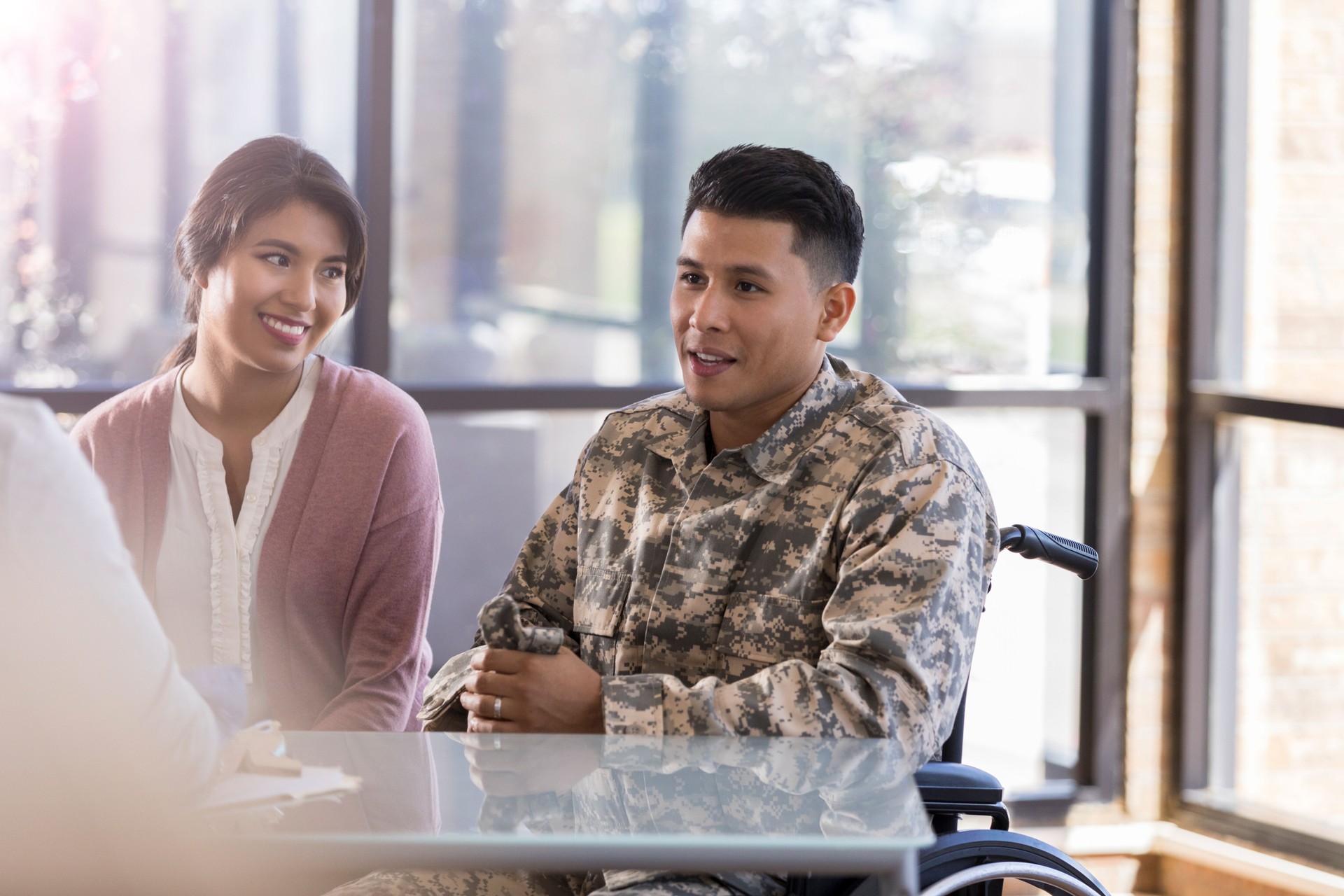 Injured soldier discusses improvements with therapist